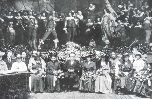 De huldiging van Dr. Cuypers ter gelegenheid van zijn negentigste verjaardag in het Rijksmuseum, op 19 Mei l.l. De Bouwmeester in 't midden van de zijnen voor het groote schuttersstuk van Van der Helst. Rechts van hem zijn zoon, de bekende architect Jos. Cuypers. Geheel links jonkvr. De Stuers, de dochter van zijn overleden vriend Victor de Stuers. Daarnaast Dr. Cuypers' kleinzoon Michiel Cuypers